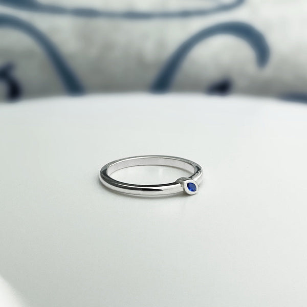 Sterling silver stacking ring with a natural blue marquise sapphire.