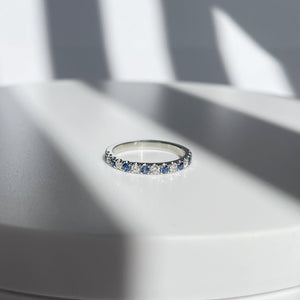 diamond and blue sapphire half eternity band in solid white gold.